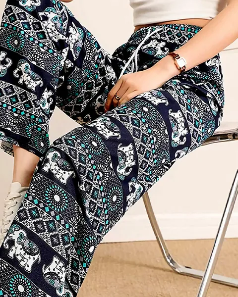 Mint elephant-print fridge pants, worn seated on a chair