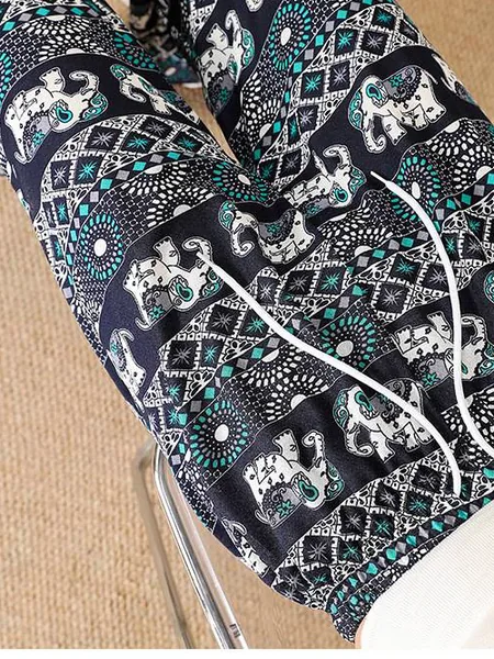 Mint elephant-print pants laid flat